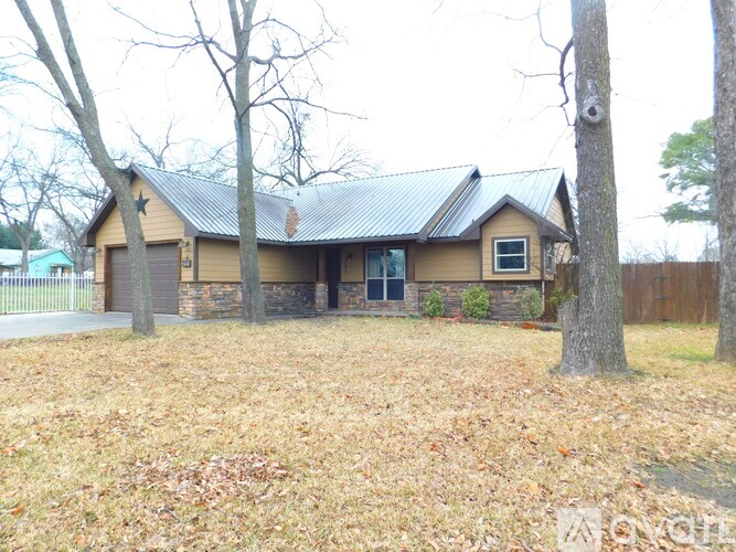 A house with a brown roof and a brown fence.