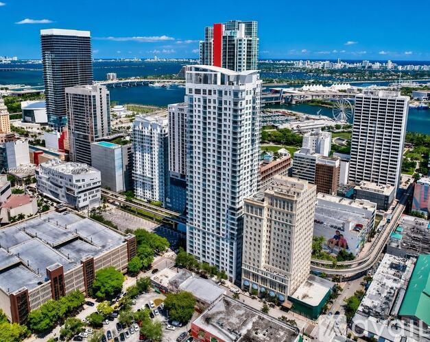 A cityscape with a mix of modern and older buildings, with a clear blue sky above.