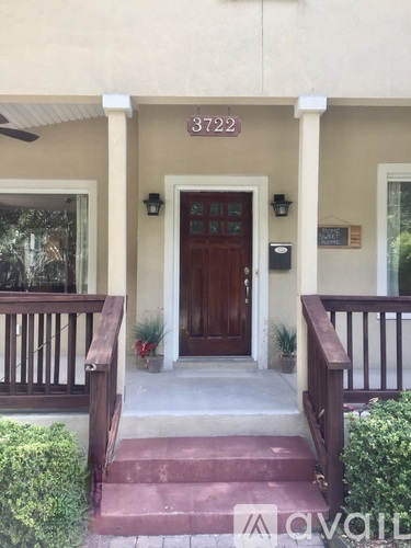 The front porch of a house with the number 3722 on the wall.
