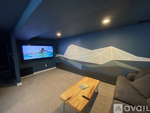 A living room with a television and a sofa.