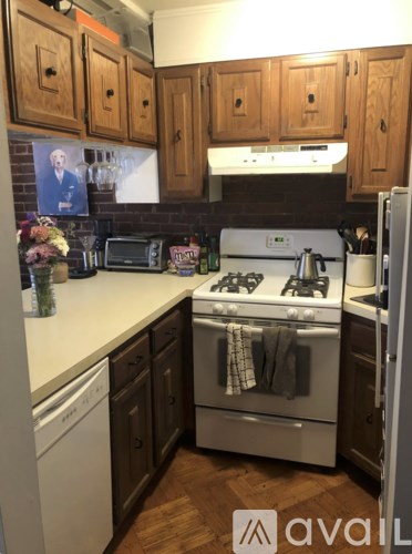 A kitchen with wooden cabinets and a white countertop.