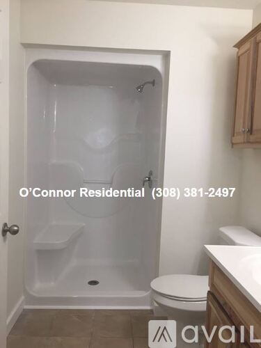 A bathroom with a toilet, sink and shower.