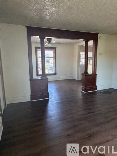 A room with wooden floors and white walls.