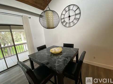 A dining room with a marble table and chairs.