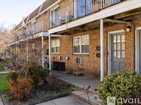 A balcony of a brick building with a blue door.