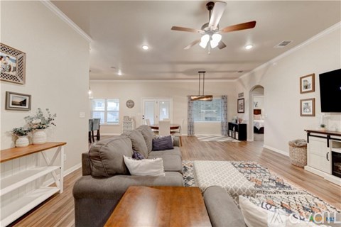 A living room with a grey couch and a wooden coffee table.