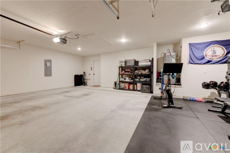 A spacious room with exercise equipment and a flag hanging on the wall.