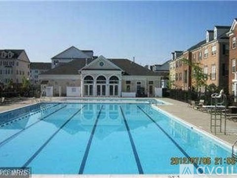 A swimming pool in front of a building with a timestamp on the bottom right.