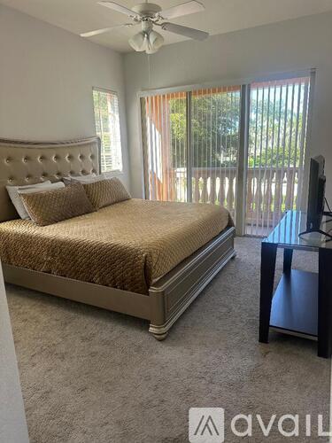 A bedroom with a large bed and a television.