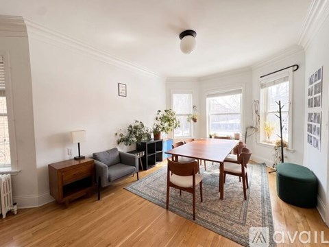 A living room with a wooden floor and furniture.