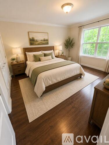 A bedroom with a large bed and a painting on the wall.