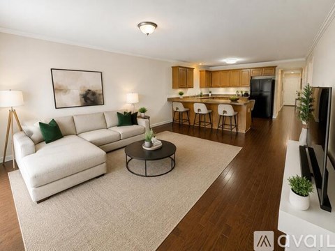 A living room with a white sofa and a coffee table.