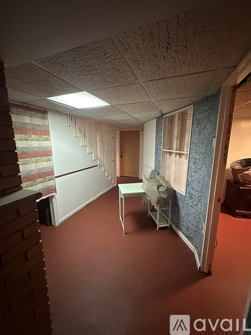 A room with a chair and a table in it.