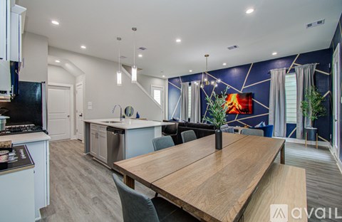 A modern kitchen with a wooden table and chairs.