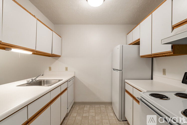 A kitchen with white cabinets and a stove top oven.