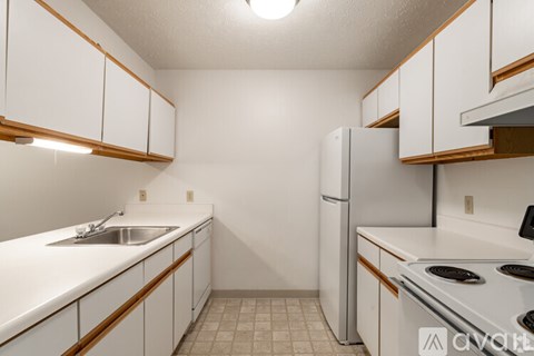 A kitchen with white cabinets and a stove top oven.