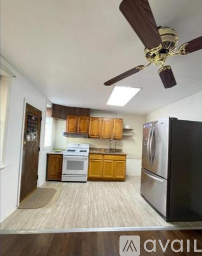 A kitchen with a white stove and a black refrigerator.