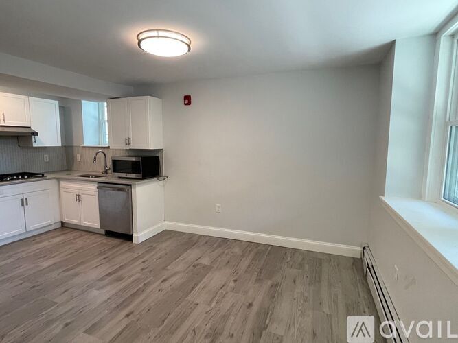 A kitchen with a stove top oven and a microwave.