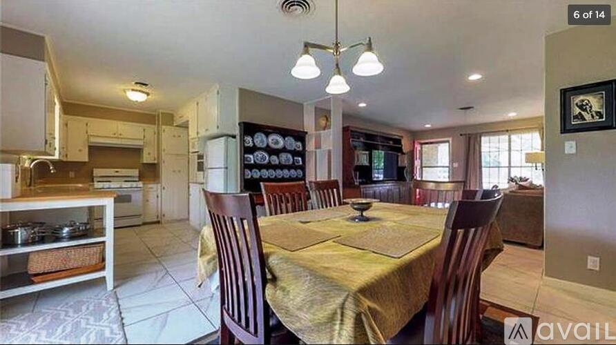 A dining room with a table set for six.