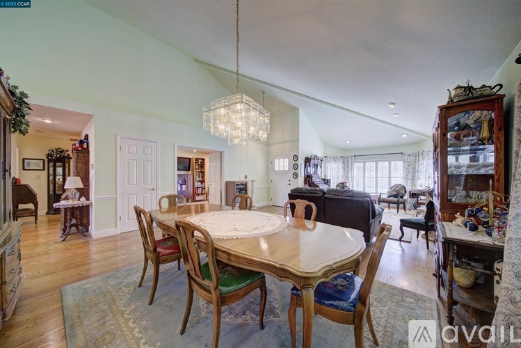 A dining room with a wooden table and chairs.