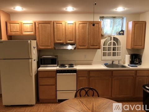 A kitchen with wooden cabinets and a white refrigerator.