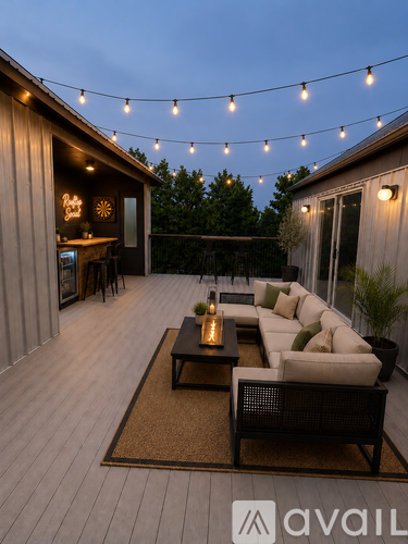 A patio with a table and chairs is illuminated by string lights.