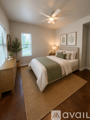 A bedroom with a bed, a window, and a rug.