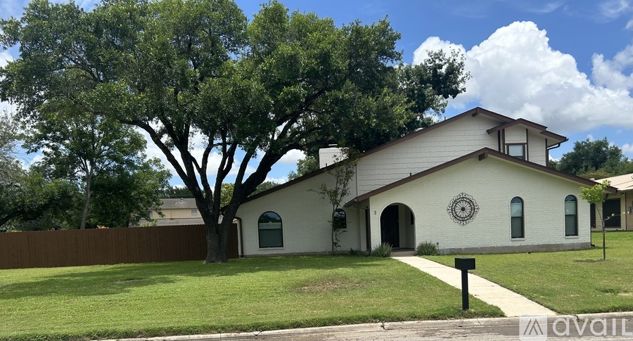 A house with a tree in front of it.