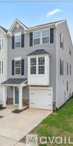 A two-story house with a garage and a covered entryway.