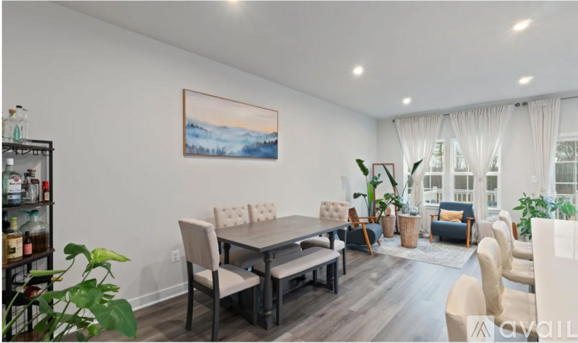 A living room with a dining table and chairs.