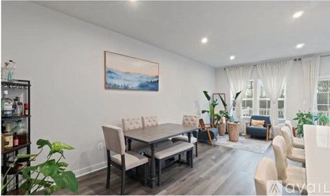 A living room with a dining table and chairs.