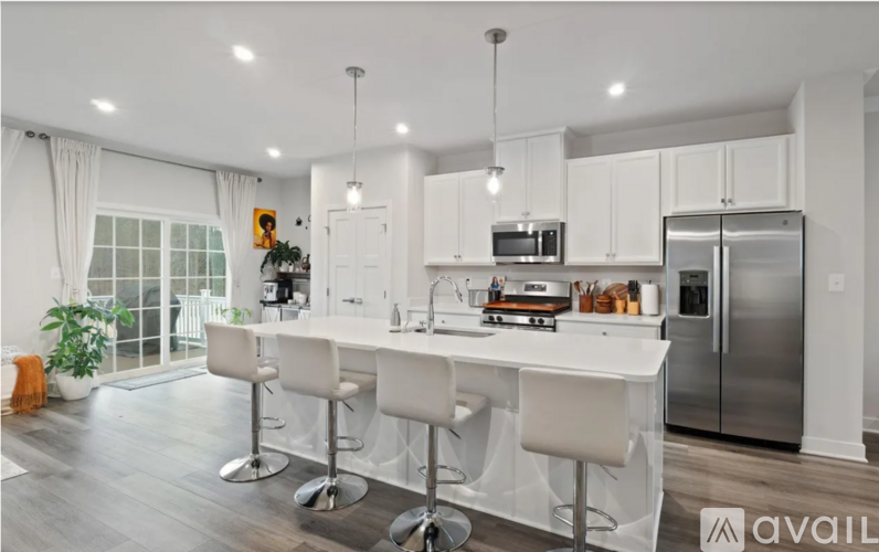 A modern kitchen with white cabinets and a center island.