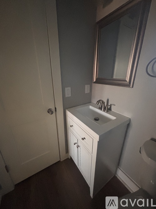 A bathroom with a sink and mirror.