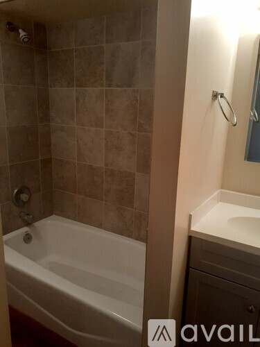 A bathroom with a tub and a sink.