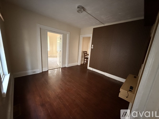 A room with wooden floors and a white ceiling with a light fixture.