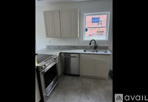 A kitchen with a stainless steel dishwasher and oven.