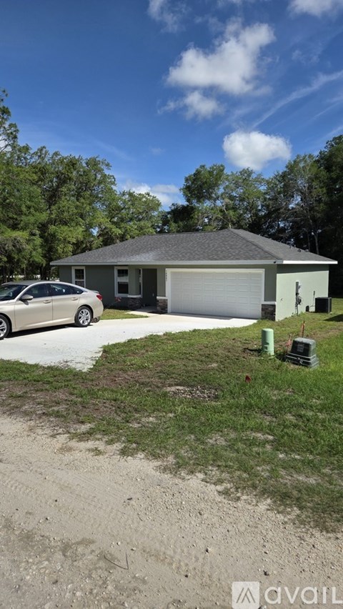 A house with a car parked in front of it.