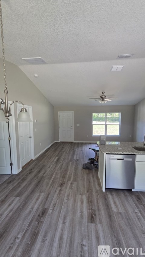 A kitchen with a dining table and a fridge.