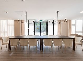 A conference room with a long table and chairs.