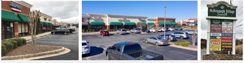A street view of a shopping area with a sign for McDouglas Village on the right.