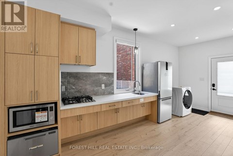 A kitchen with wooden cabinets and a modern design.