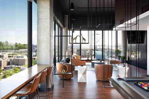A modern dining room with a view of the cityscape.