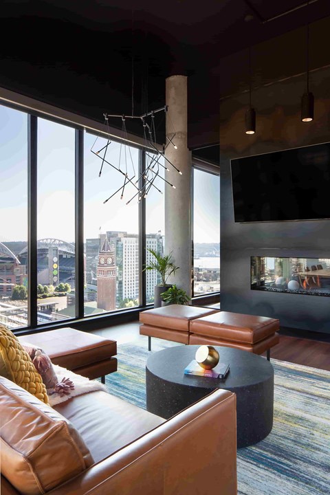 A modern living room with a large window overlooking a cityscape.