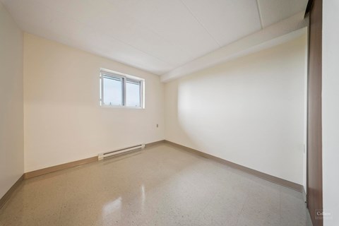 A room with a window and a floor that reflects light.