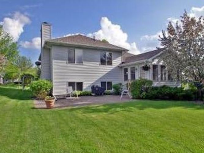 A house with a well-kept lawn in front.