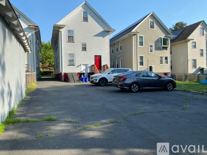 A parking lot with cars and apartment buildings in the background.