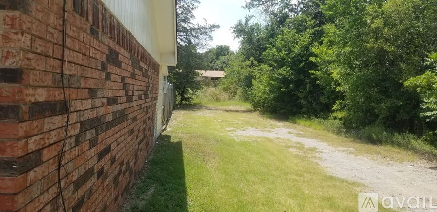 A brick wall with a grassy area in the background.
