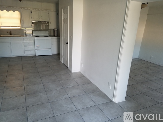 A kitchen with white cabinets and appliances is shown.