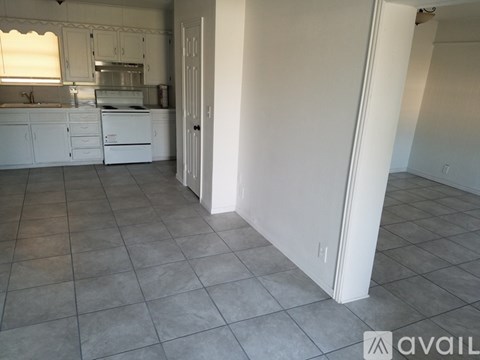 A kitchen with white cabinets and appliances is shown.
