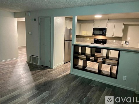 A kitchen area with a refrigerator, microwave, and oven.
